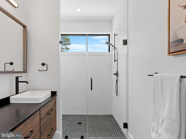 bathroom with vanity, a shower stall, and recessed lighting