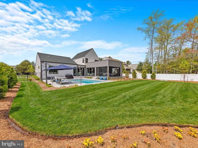rear view of property with a sunroom, a fenced backyard, a yard, and a gazebo