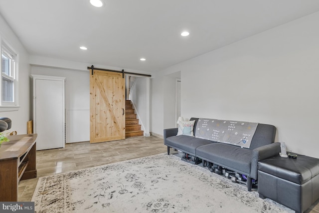 living area featuring recessed lighting, a barn door, stairs, and wood finished floors