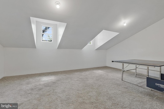 bonus room with carpet and vaulted ceiling