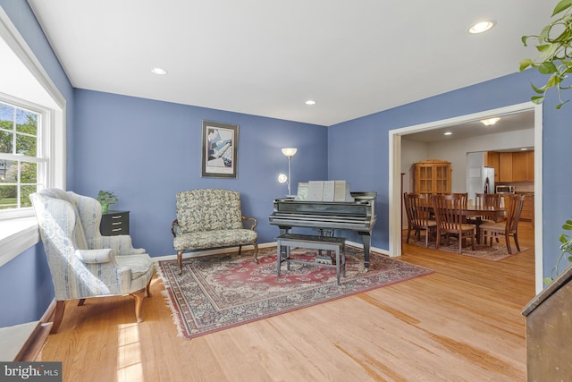 living area with recessed lighting and wood finished floors