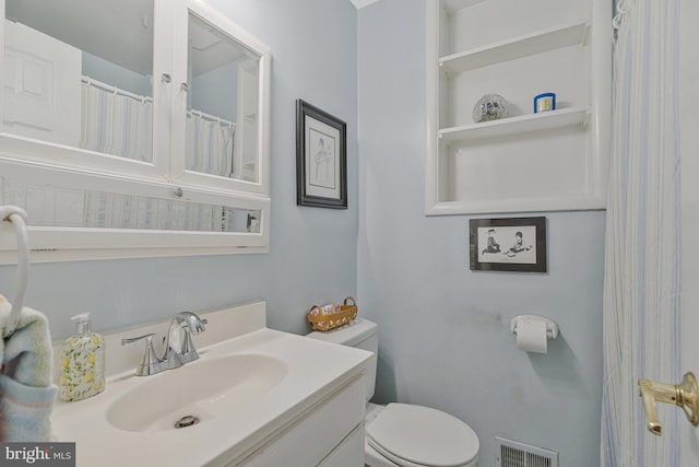 bathroom with visible vents, toilet, and vanity