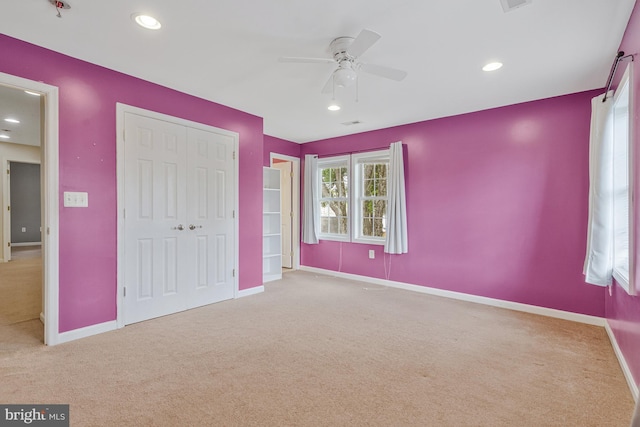 unfurnished bedroom with carpet floors, recessed lighting, baseboards, and a closet