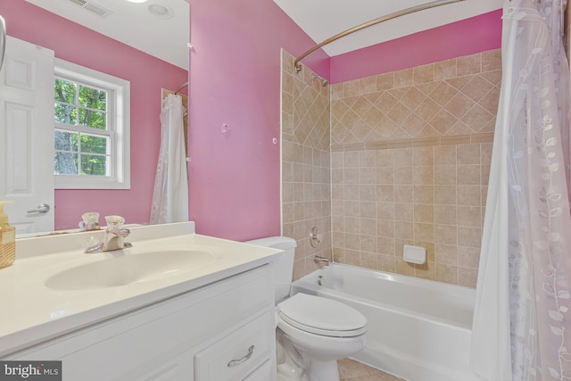 bathroom with visible vents, vanity, toilet, tile patterned floors, and shower / tub combo