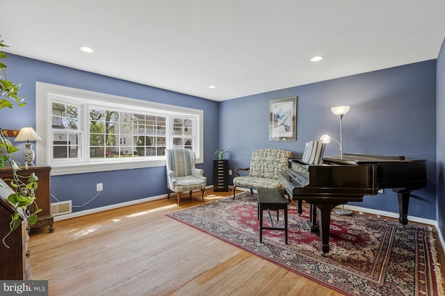 living area featuring baseboards, recessed lighting, and wood finished floors