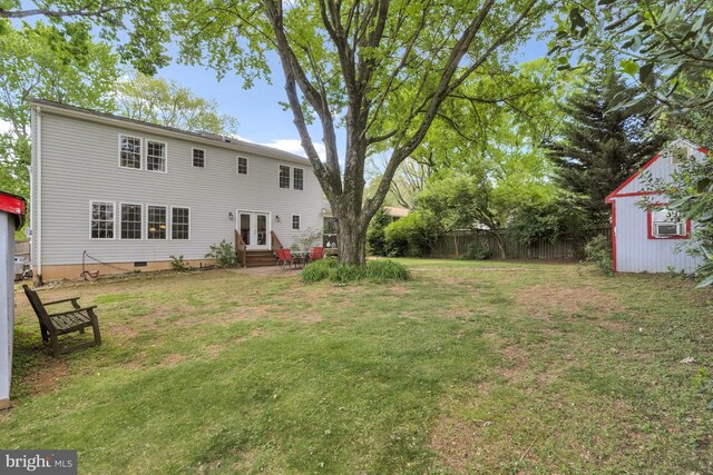back of house with fence, french doors, crawl space, entry steps, and a lawn