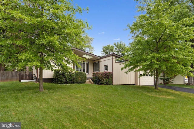 11801 Cherry Grove Dr, Gaithersburg, MD 20878 - view of front of property featuring aphalt driveway, fence, a garage, and a front yard