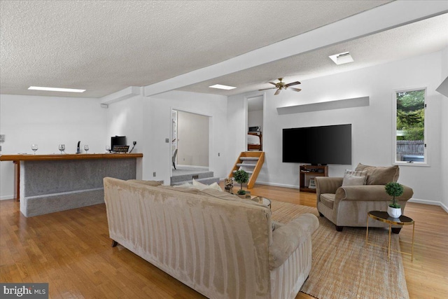 11801 Cherry Grove Dr, Gaithersburg, MD 20878 - living room featuring wood finished floors, a ceiling fan, a textured ceiling, stairway, and baseboards