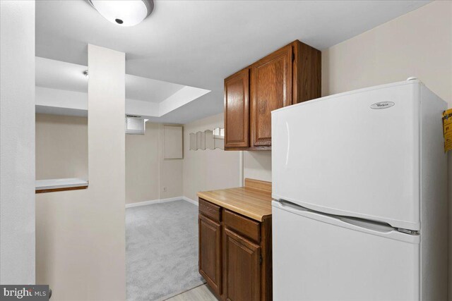11801 Cherry Grove Dr, Gaithersburg, MD 20878 - kitchen with freestanding refrigerator, baseboards, brown cabinets, light countertops, and light colored carpet