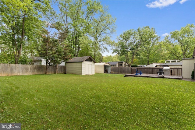 11801 Cherry Grove Dr, Gaithersburg, MD 20878 - view of yard featuring an outdoor structure, a shed, a fenced backyard, and a wooden deck