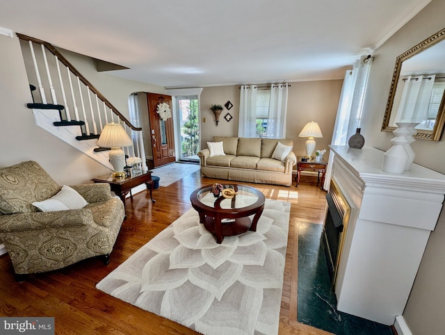 460 Burmont Rd, Drexel Hill, PA 19026 - living room featuring arched walkways, ornamental molding, wood finished floors, and stairway