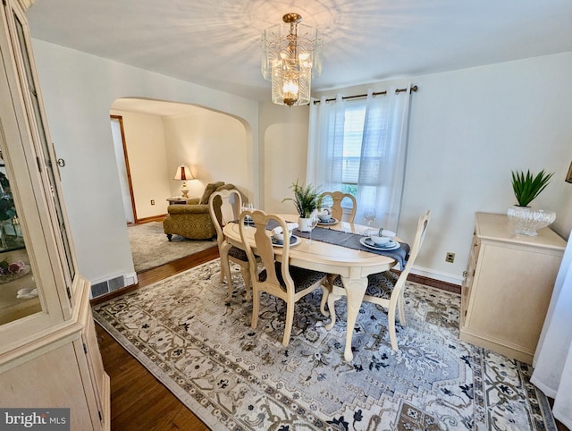 460 Burmont Rd, Drexel Hill, PA 19026 - dining area featuring visible vents, arched walkways, wood finished floors, baseboards, and a chandelier