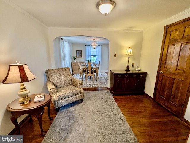 460 Burmont Rd, Drexel Hill, PA 19026 - living area featuring crown molding, arched walkways, a chandelier, baseboards, and dark wood-style floors