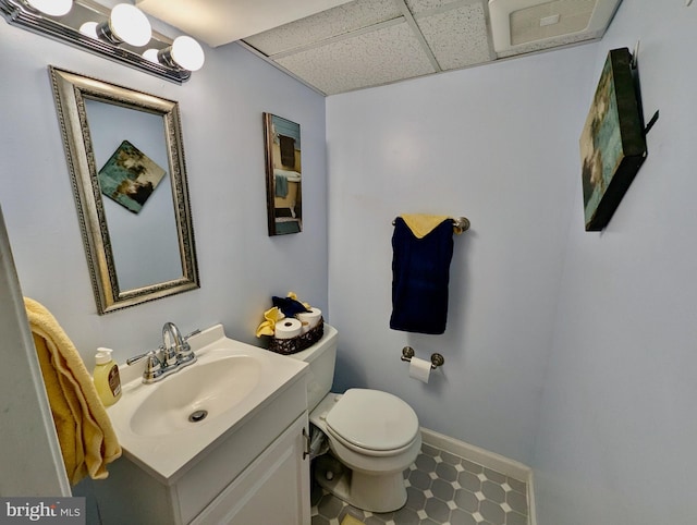 460 Burmont Rd, Drexel Hill, PA 19026 - half bath featuring visible vents, a paneled ceiling, vanity, baseboards, and toilet