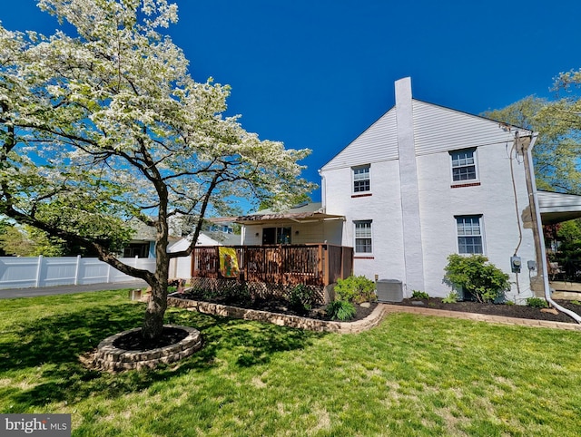 460 Burmont Rd, Drexel Hill, PA 19026 - view of side of home with fence, a deck, cooling unit, a chimney, and a yard