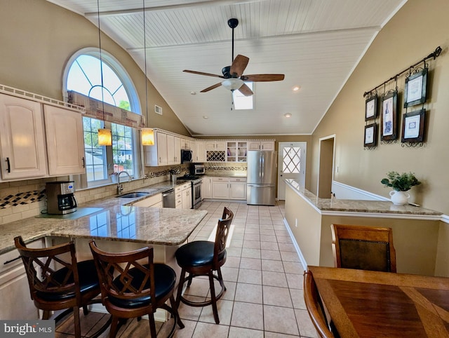 460 Burmont Rd, Drexel Hill, PA 19026 - kitchen with a sink, stainless steel appliances, a peninsula, light tile patterned floors, and backsplash