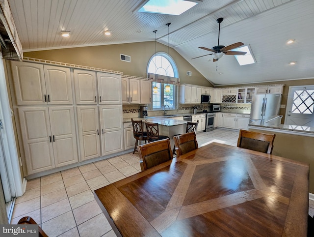 460 Burmont Rd, Drexel Hill, PA 19026 - dining area featuring visible vents, ceiling fan, light tile patterned floors, and a skylight