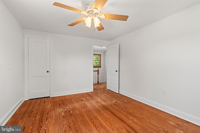 unfurnished bedroom featuring baseboards, ceiling fan, and wood finished floors