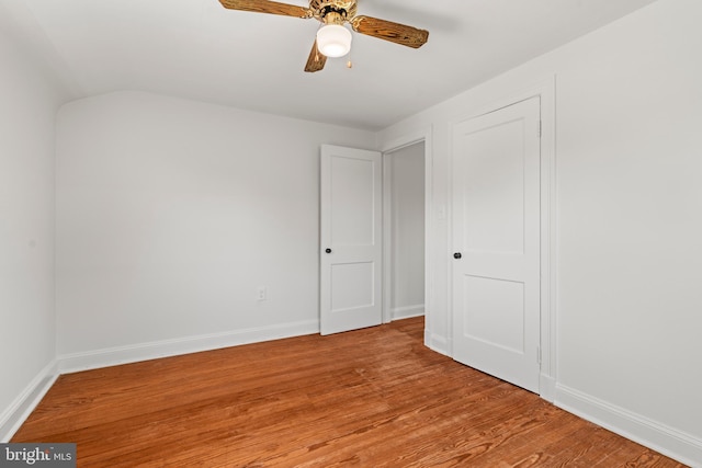 unfurnished bedroom with baseboards, ceiling fan, and light wood finished floors