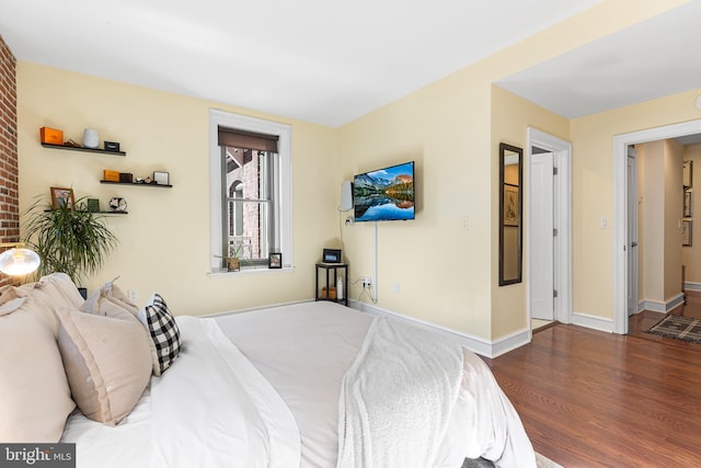 bedroom featuring baseboards and wood finished floors