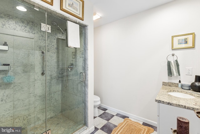 bathroom featuring toilet, tile patterned floors, a shower stall, and vanity