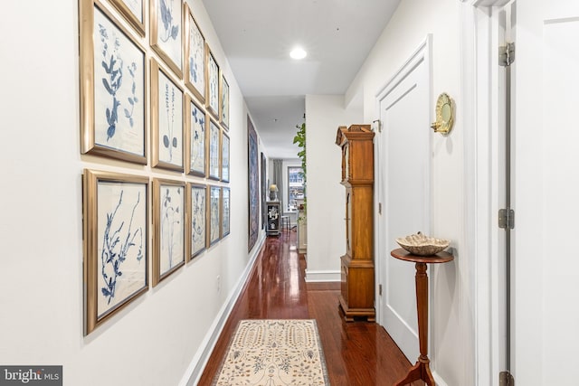 hall with baseboards, recessed lighting, and wood finished floors