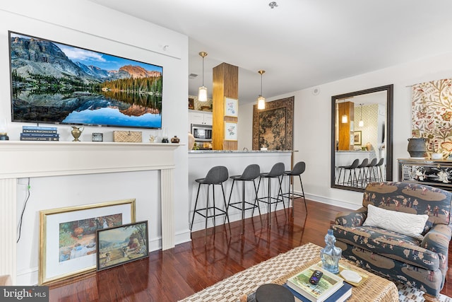 living room featuring baseboards and wood finished floors