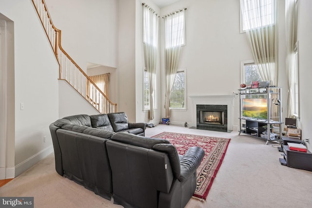17 Grant Dr, Cream Ridge, NJ 08514 - carpeted living area featuring a high ceiling, stairway, healthy amount of natural light, baseboards, and a high end fireplace