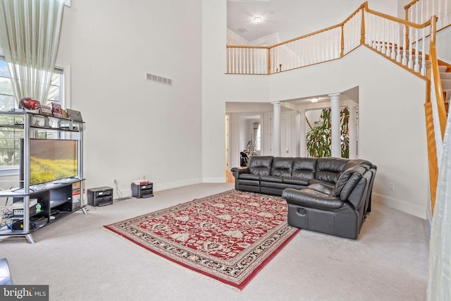 17 Grant Dr, Cream Ridge, NJ 08514 - carpeted living room featuring ornate columns, a high ceiling, baseboards, and stairs