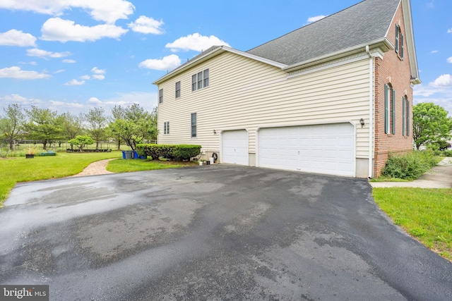 17 Grant Dr, Cream Ridge, NJ 08514 - view of property exterior with asphalt driveway, a garage, a lawn, a shingled roof, and brick siding