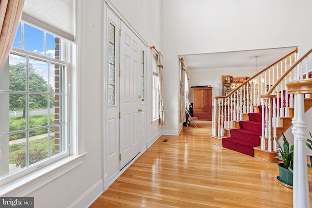17 Grant Dr, Cream Ridge, NJ 08514 - foyer entrance featuring light wood-style flooring, stairway, baseboards, a towering ceiling, and crown molding