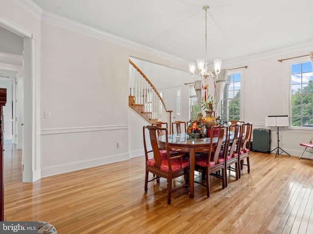 17 Grant Dr, Cream Ridge, NJ 08514 - dining space featuring radiator heating unit, light wood finished floors, a chandelier, crown molding, and stairway
