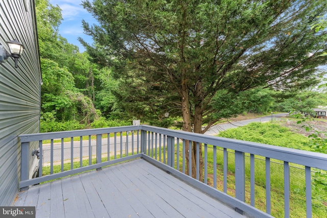 wooden terrace with a lawn