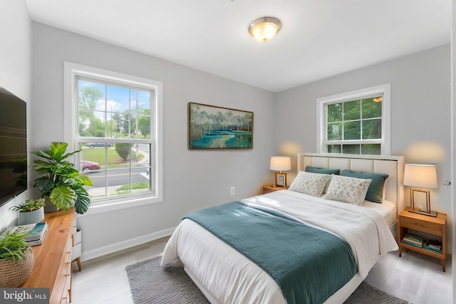 bedroom featuring multiple windows and baseboards
