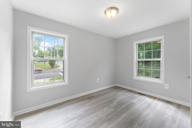 empty room with wood finished floors and baseboards