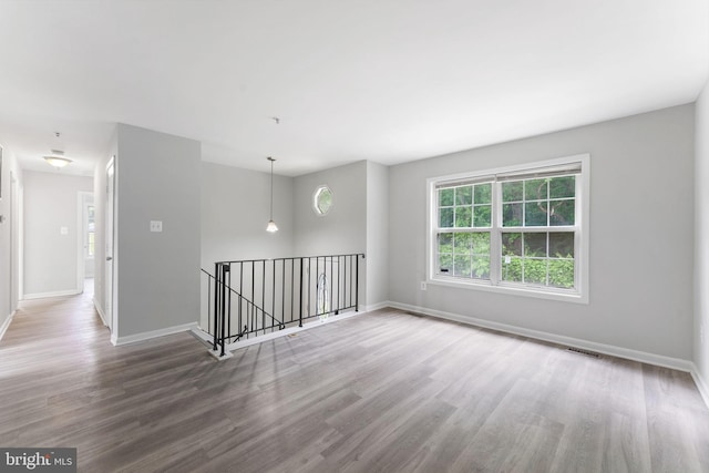 unfurnished room with wood finished floors and baseboards