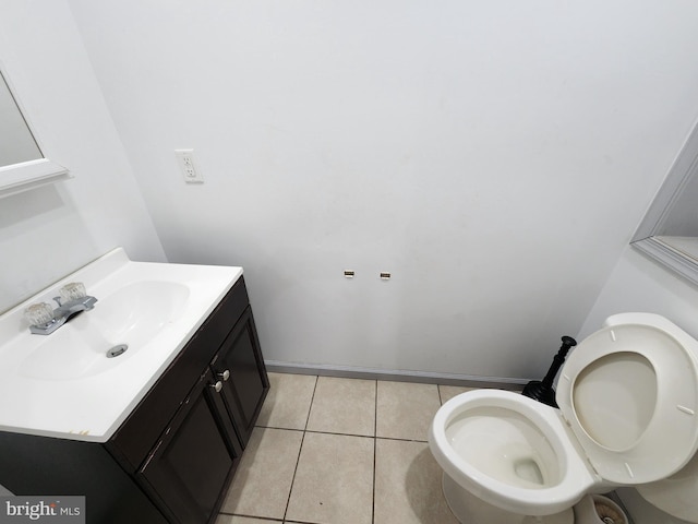bathroom featuring vanity, tile patterned floors, and toilet