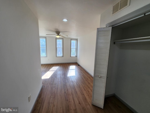 unfurnished bedroom featuring visible vents, baseboards, a closet, recessed lighting, and dark wood-type flooring