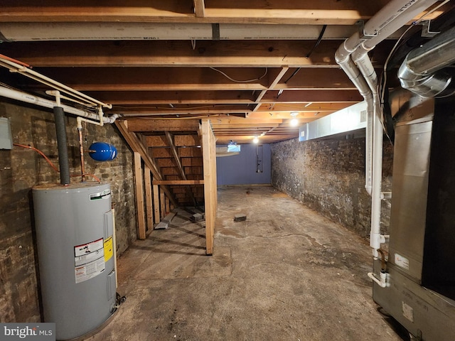 unfinished basement featuring stairway and electric water heater