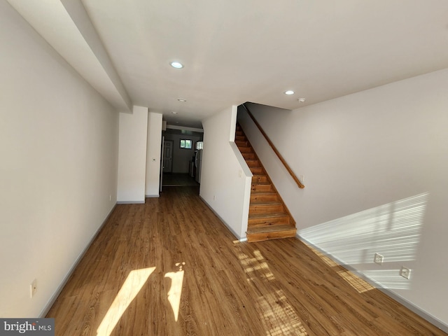 interior space featuring baseboards, recessed lighting, wood finished floors, and stairway