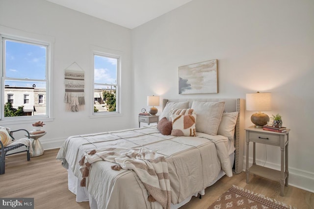 bedroom featuring baseboards and light wood-style flooring