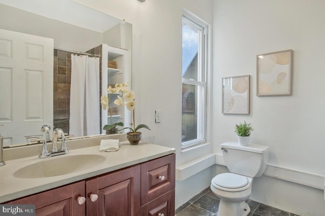full bathroom featuring vanity, stone finish floor, toilet, and a shower with curtain
