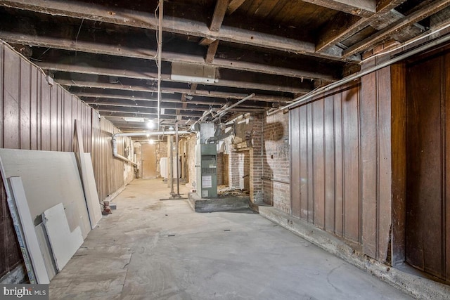 unfinished basement featuring heating unit