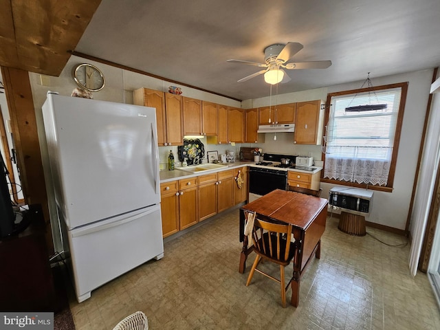kitchen with a ceiling fan, light countertops, a sink, under cabinet range hood, and white appliances