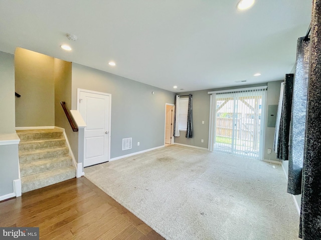 419 Foxglove Way Unit 106, Stafford, VA 22554 - unfurnished living room featuring recessed lighting, baseboards, wood finished floors, visible vents, and stairway