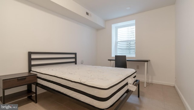 bedroom featuring tile patterned floors, baseboards, and visible vents