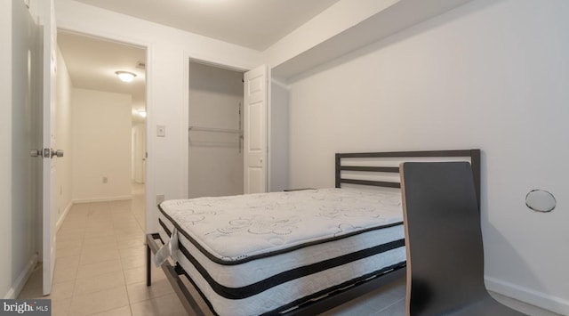 bedroom featuring light tile patterned floors and baseboards