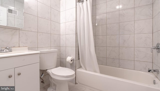 full bathroom featuring visible vents, tile walls, shower / tub combo, vanity, and toilet