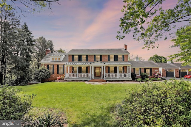 2812 Pheasant Ln, Clarksburg, MD 20871 - colonial-style house with a chimney, covered porch, brick siding, and a front lawn