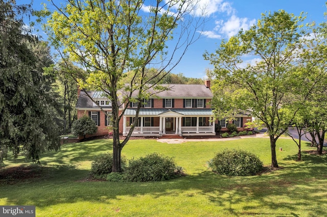 2812 Pheasant Ln, Clarksburg, MD 20871 - colonial home with covered porch, a front yard, a chimney, and brick siding